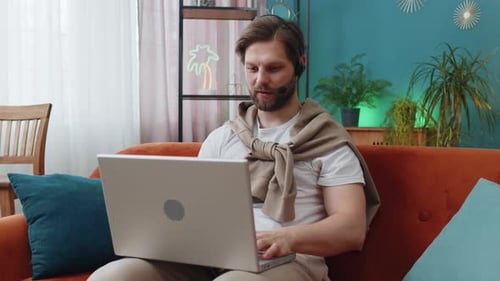 Young Man Freelance Worker Call Center or Support Service Operator Helpline Having Talk with Client