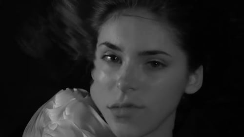 Sad young woman underwater in black and white, retro, close up