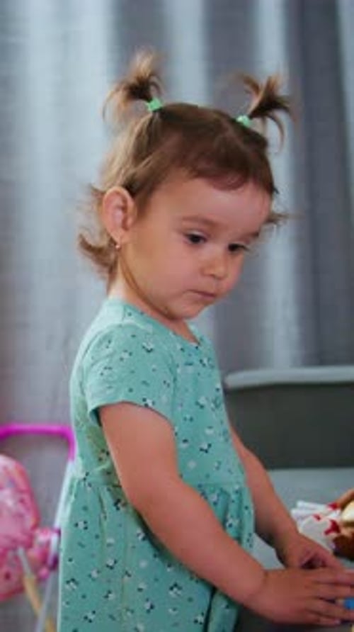 Cute Child Plays with Toys at Home