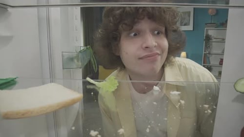 Young Man Shocked by Refrigerator Contents While on Phone