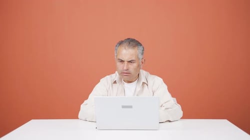 Man Celebrating Success in Front of Laptop