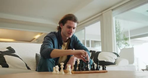 Young Adult Playing Chess in Living Room