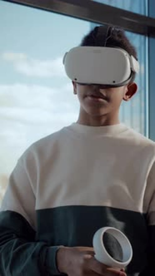 Teen Wearing Virtual Reality Headset with Hand Controller