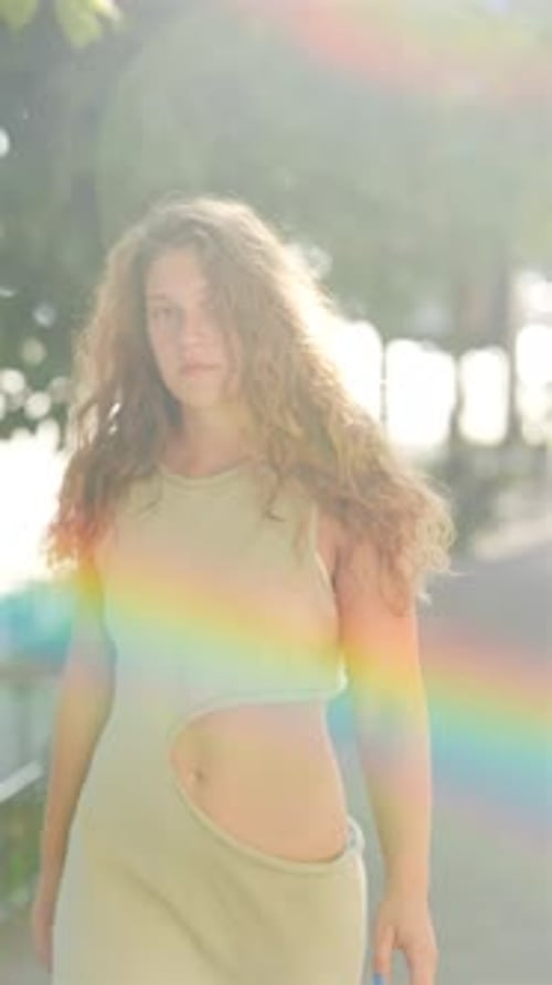 With Her Curly Hair and an Athletic Vibe a Young Girl Walks Through the City on a Summer Day