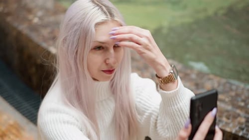 Contemporary Woman Adjusts Hair Takes Selfie By Mall Fountain
