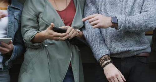 Group of People Using Smartphones Together in City