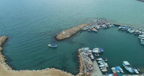 Aerial View Of Small Boats Entering A Calm Stone Harbor