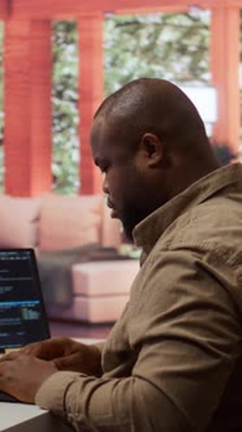 Vertical Video Software Engineer Coding on a Laptop Focusing on Deep Learning
