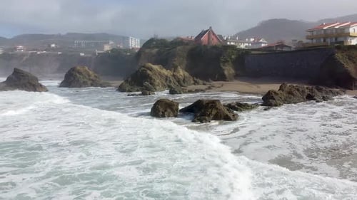 Aerial drone view of the beach of Bakio in the Basque Country in a foggy day