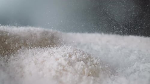 Powdered Sugar Bounces on Surfaces From Vibration of Table