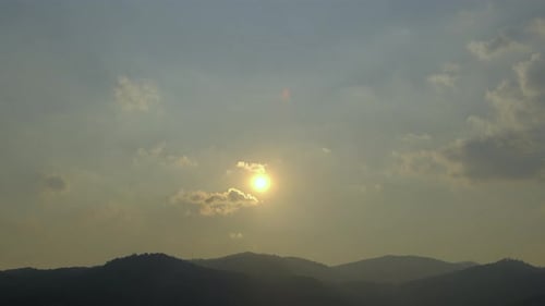 Sunset Over Mountain Range with Golden Light Beams