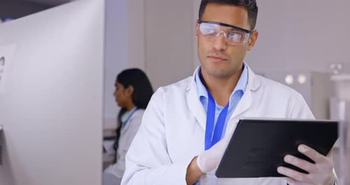 Scientist Uses Tablet in Modern Lab