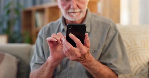 Senior Adult Using Smartphone Device Indoors