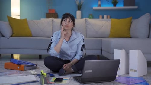 Home office worker woman thinking looking at camera.