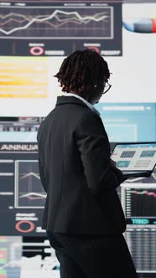 Vertical Video Business Professional Using Laptop to Review Performance Dashboards Metrics