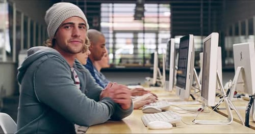 4k video of a group of university students working on computers in a classroom