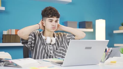 Student looking at laptop gets upset. Negative exam results.