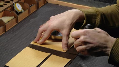 Hands of a Person Who Works with Leather in Workplace