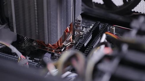 Closeup Hands of Unrecognizable Technician Using Screwdriver to Fix PC CPU Air Cooling System