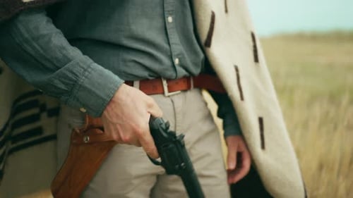 Man removes revolver from holster