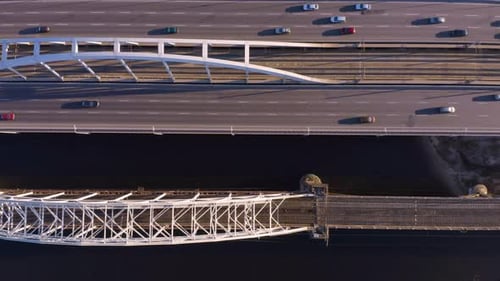 Birds Eye View From Drone of Bridge Road Over River with Moving Cars