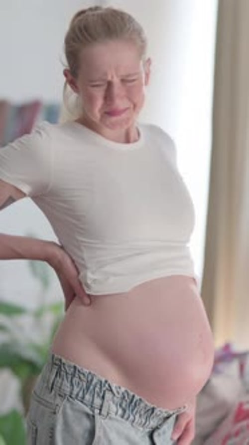 Standing Pregnant Woman having Back Pain, Vertical Video