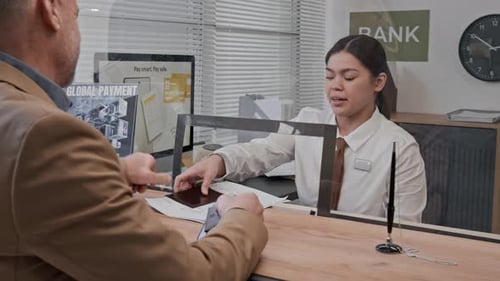 Customer and Bank Teller Interacting at Counter with Glass Divider