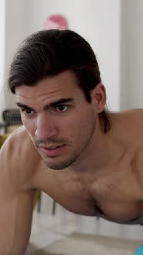 Shirtless Man Does Plank Exercise on Yoga Mat