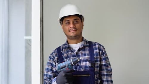 Construction Worker Holding Drill Wearing Hard Hat