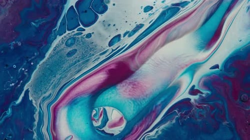 Blue and white liquid colors moving slowly on a surface