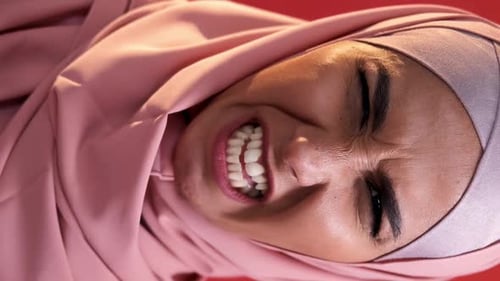 Woman in Head Covering Displays Discomfort