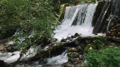 An amazing beautiful waterfall view of the river streaming on the rocks in the forest.