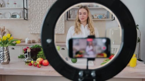 Woman Filming Food Vlog in Kitchen with Ring Light