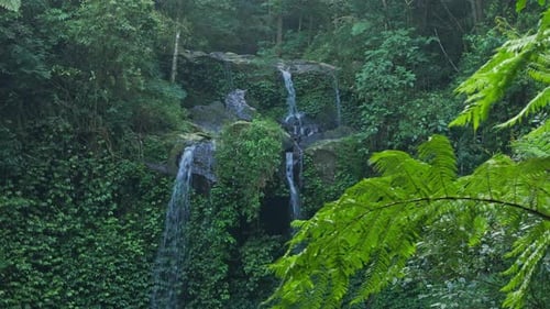 Drone view pristine tropical forest scene with waterfalls hidden deep in the rainforest