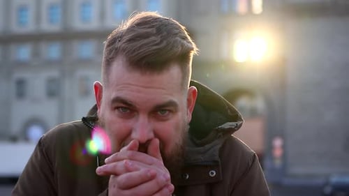 A Young Man Freezes in the Winter in the City
