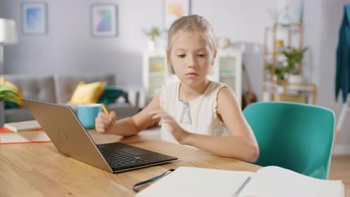 Girl Studies with Laptop at Home on Table