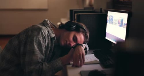 Desk, sleeping student and man on headphones, tired or stress at night on computer