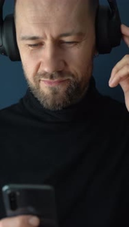 Man with Headphones Using Mobile Device