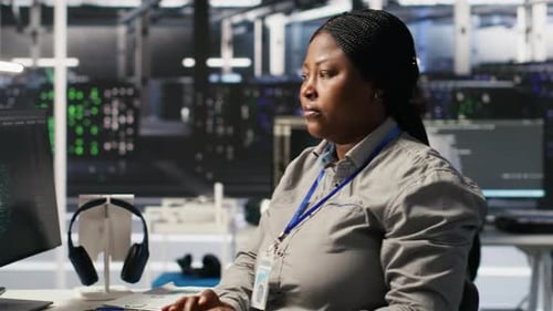 Data Center Programmer Coding on PC Doing Software Updates for AI Systems