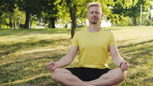 Man Meditating Outdoors in a Peaceful Park