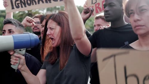 Adults Protest with Signs and Megaphone
