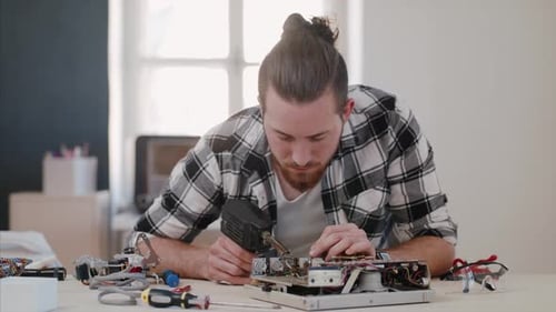 Young Man at Repair Cafe Repairing Household Electrical Devices