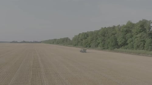 Aerial View of Farmer Fertilizing Agricultural Field Spreading Mineral Fertilizer in Slow Motion