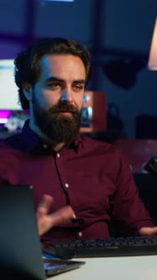 Vertical Video Man in Studio Reviewing Gaming Keyboard Received From Sponsoring Brand