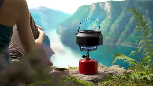 Kettle on Camping Stove in Remote Landscape