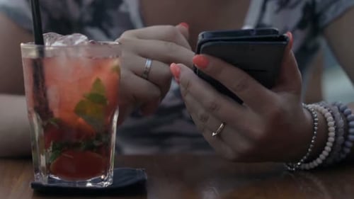 Female Hands Texting Smartphone Sitting by Table in Cafe 30s