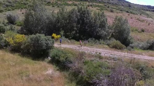 Runners Jogging on Dirt Road in Rural Landscape