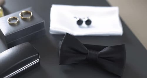 Wedding Accessories For The Groom Laying On Table