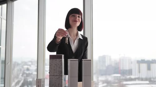 Focus on Keys in Hand of Real Estate Manager Homeowner Businesswoman