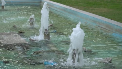 Handheld shot of water fountain pumping water